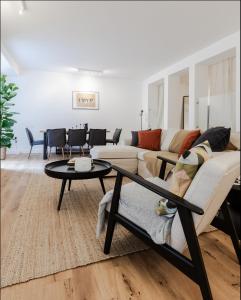 a living room with a couch and a table at Sunlit Family Home in Hampstead in London