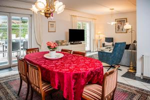 uma sala de estar com uma mesa com uma toalha de mesa vermelha em Haus Helga em Idar-Oberstein