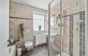 a bathroom with a shower and a toilet and a sink at 3 Bedroom Stunning Home In Haren Ems in Dankern +9 photos