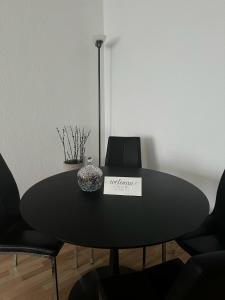 a black dining room table with a sign on it at Captivating 2-Bed Apartment in Viby J in Viby