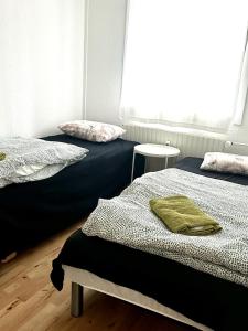 two beds sitting next to each other in a room at Captivating 2-Bed Apartment in Viby J in Viby