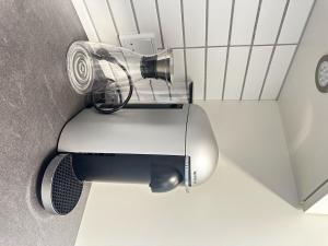 a hair dryer in the corner of a bathroom at Captivating 2-Bed Apartment in Viby J in Viby