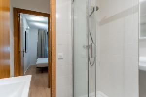 a bathroom with a shower with a glass door at AB Cozy Flat in El Born in Barcelona