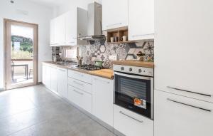 a white kitchen with white cabinets and an oven at Stunning Home In Laureana Cilento in Laureana Cilento