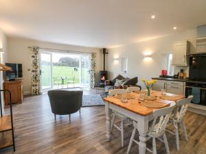 a kitchen and living room with a table and chairs at The Barn in Bishop Auckland
