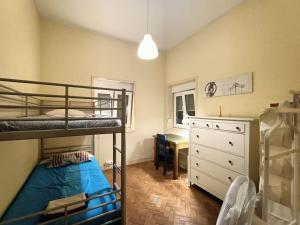 a bedroom with two bunk beds and a desk at Agra Pet House I in Maia