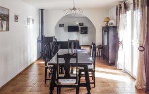 a dining room with a black table and chairs at Awesome Home In Pierrelatte With Wifi in Saint-Just-la-Pendue