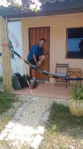 a man standing in front of a house at navaa Bungalow in Phra Ae beach