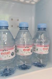 three bottles of water are sitting in a refrigerator at Studio Cabin in Belfast in Belfast