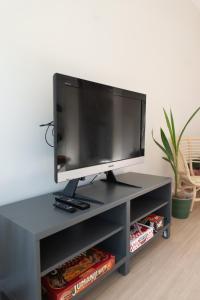 a black entertainment center with a flat screen tv at Studio Cabin in Belfast in Belfast