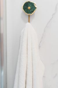 a white towel hanging on a wooden hook at Studio Cabin in Belfast in Belfast