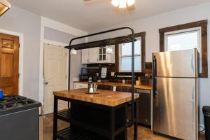 a kitchen with a stainless steel refrigerator and a table at Flexhome Logan Square 2BR B2 with Laundry and Patio - READ INFO in Chicago