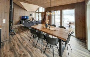 a dining room with a wooden table and chairs at Gorgeous Home In Evje With Lake View in Evje