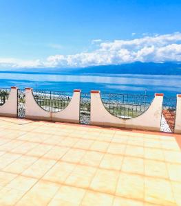a balcony with a view of the ocean at Villa Pina in Reggio Calabria
