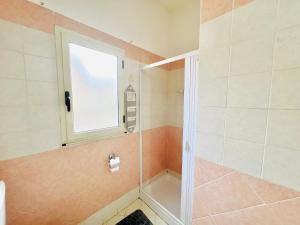 a bathroom with a shower with a window at Villa Pina in Reggio di Calabria