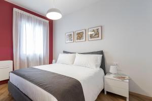 a bedroom with a large bed and a window at Il Chiostro di Santa Caterina in Vimercate