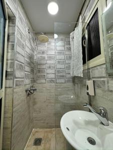 a bathroom with a sink and a shower at Pyramids Gardens Hotel - فندق حدائق الاهرام in Cairo