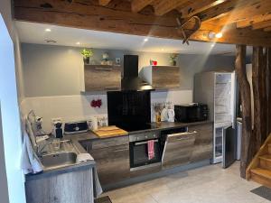 a kitchen with a sink and a refrigerator at Maison de vacances in Melles