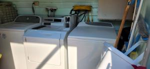 a washer and dryer sitting in a room at Meyenburg Family Room in Mount Morgan
