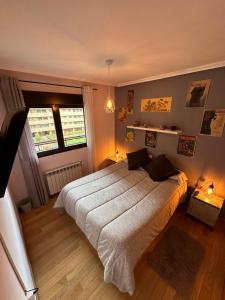 a bedroom with a large bed and a window at El encanto de Seseña in Seseña
