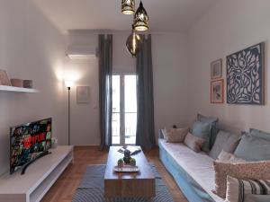 a living room with a couch and a table at Beautiful Athenian apartment next to the center in Athens
