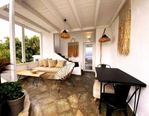 a living room with a couch and a table at Papikinou Bay Suites in Adamantas