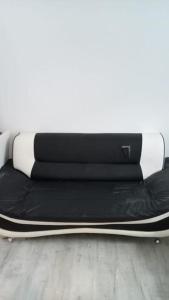 a bed with black and white sheets on it at Bike Park 5 miles2-Bed cottage in Merthyr Vale in Merthyr Tydfil