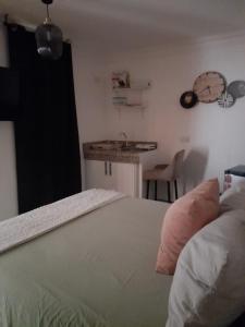 a bedroom with a bed and a sink and a table at Apartamento centro de la ciudad 2 in San Pedro de Macorís