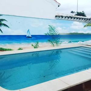 a swimming pool with a mural of a beach at 3 bedrooms villa with private pool furnished terrace and wifi at Encinarejo de Cordoba in Encinarejo De Córdoba