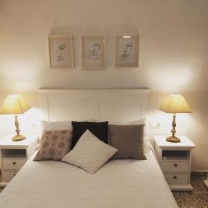 a bedroom with a white bed with two lamps at 3 bedrooms villa with private pool furnished terrace and wifi at Encinarejo de Cordoba in Encinarejo De Córdoba