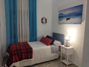 a bedroom with a bed and a lamp on a night stand at 3 bedrooms villa with private pool furnished terrace and wifi at Encinarejo de Cordoba in Encinarejo De Córdoba