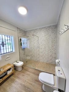 a bathroom with a toilet sink and a shower at 3 bedrooms villa with private pool furnished terrace and wifi at Encinarejo de Cordoba in Encinarejo De Córdoba