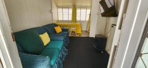 a living room with a green couch and a table at Meyenburg Unit 1 in Mount Morgan