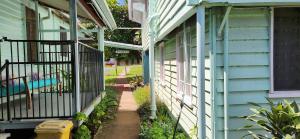 a porch of a blue house with a fence at Meyenburg Family Room in Mount Morgan +21 photos