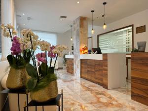 a kitchen with two vases with flowers on a table at Hotel Piccadilly in Lido di Jesolo