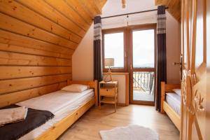 Katil atau katil-katil dalam bilik di Rusińska Osada 36 Apartments