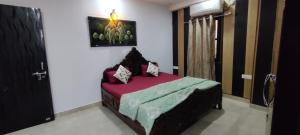 a bedroom with a bed in a room with a door at 360 degree mountain view penthouse in Rishīkesh