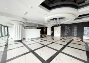 a lobby with a black and white tile floor and columns at Hanza Tower Platinium 26 Apartments Jacuzzi & Pool & Sauna in Szczecin