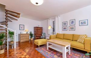a living room with a couch and a table at 3 Bedroom Nice Apartment In Mali Losinj in Mali Lošinj