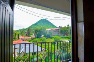 a view of a mountain from a balcony at The Bay House in Homa Bay