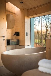 a large bath tub in a bathroom with a window at Kanna in Chipping Norton