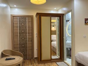 a room with a door with a mirror and a bedroom at Pyramids Gardens Hotel in Cairo +161 photos