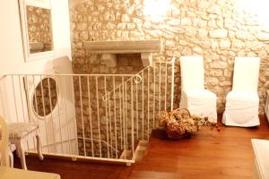 a room with a staircase with a stone wall at Residenza Dei Tolomei Polcenigo in Polcenigo
