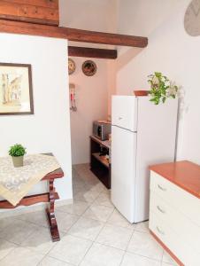 una cucina con frigorifero bianco e tavolo di Dhalia Appartamenti Trapani a Trapani