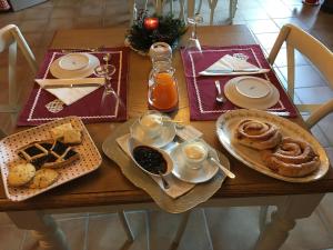 una mesa de madera con platos de comida. en B&B La Casa della Nonna - L'Antico Fienile en San Martino al Cimino