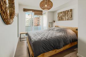 ein Schlafzimmer mit einem Bett und einem großen Fenster in der Unterkunft Caravelle 0501 in De Panne