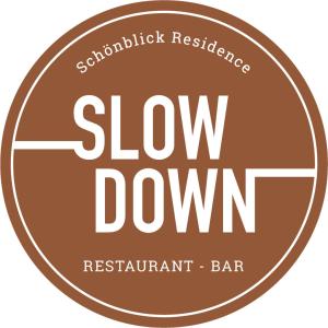 a brown slow down restaurant bar logo at Schönblick Residence - Absolut Alpine Apartments in Zell am See