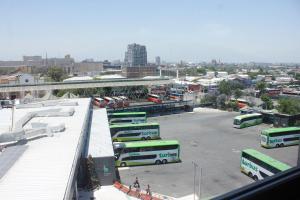 a group of buses parked in a parking lot at Nobile Inn Santiago in Santiago