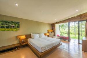 a bedroom with a bed and a large window at Villa R331 Forest Flamingo Dai Lai Resort in Phúc Yên