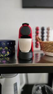 a red and white coffee maker sitting on a counter at Vue Meuse, en face de la citadelle in Dinant